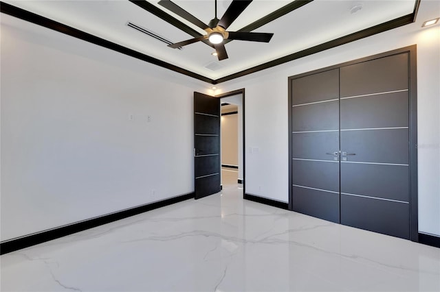 unfurnished bedroom with ceiling fan, crown molding, and a closet