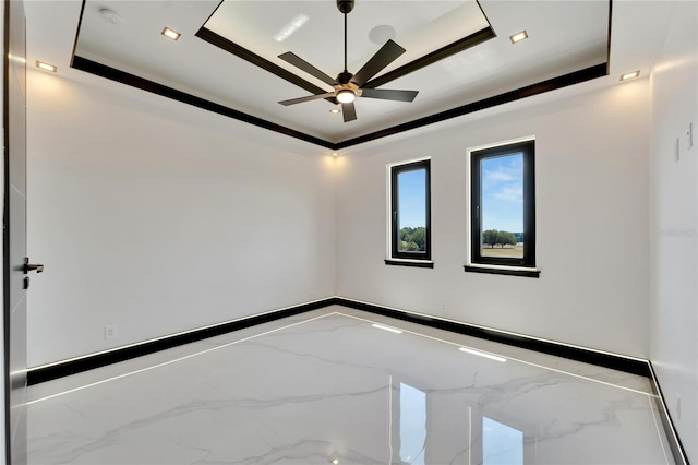 unfurnished room with ceiling fan, crown molding, and a tray ceiling