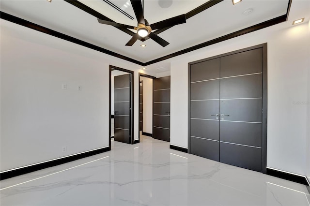 unfurnished bedroom featuring ceiling fan, a closet, and crown molding