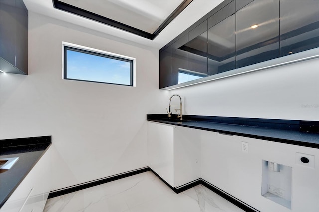 bathroom featuring sink and a tray ceiling