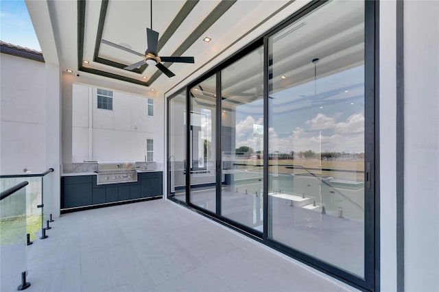 interior space featuring ceiling fan and a raised ceiling