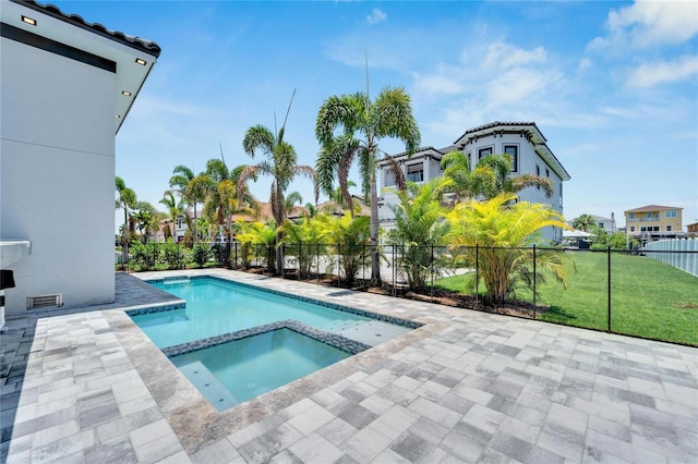 view of swimming pool with a lawn and an in ground hot tub