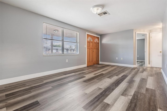 unfurnished room with hardwood / wood-style floors