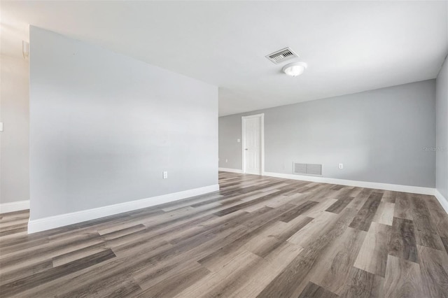 spare room with hardwood / wood-style floors