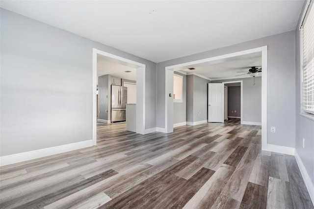 empty room featuring ceiling fan and hardwood / wood-style floors