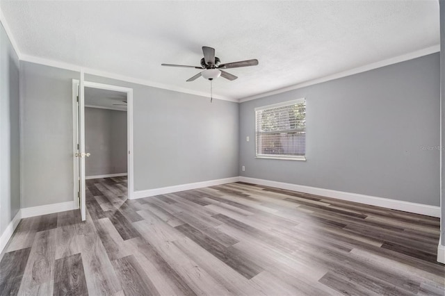 unfurnished bedroom with ornamental molding, ceiling fan, hardwood / wood-style floors, and a closet