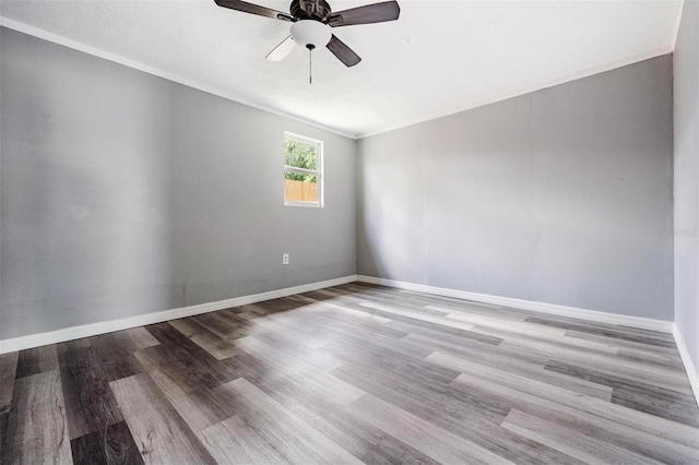 empty room featuring wood-type flooring, ornamental molding, and ceiling fan