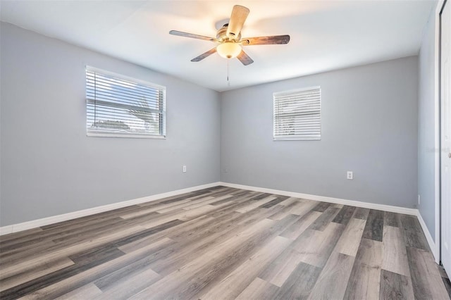 spare room with hardwood / wood-style flooring and ceiling fan