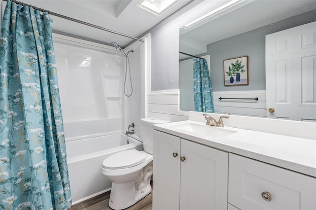 full bathroom featuring hardwood / wood-style floors, shower / bathtub combination with curtain, toilet, and vanity