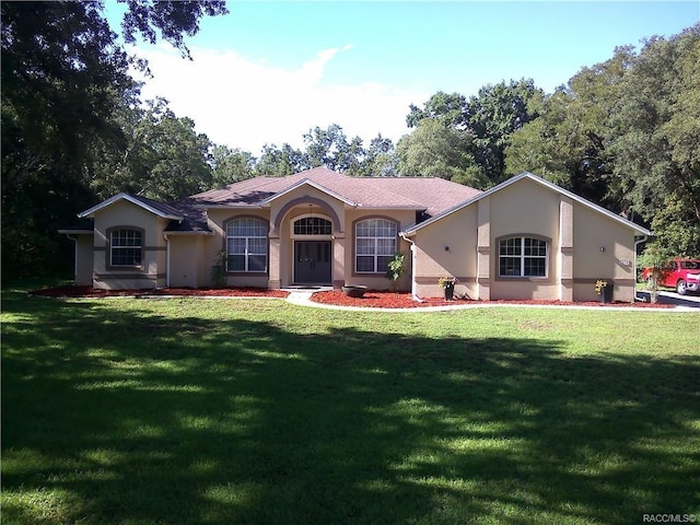 mediterranean / spanish-style home featuring a front lawn