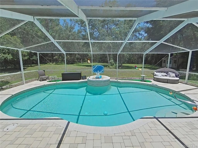 view of pool featuring a yard, a patio, and glass enclosure