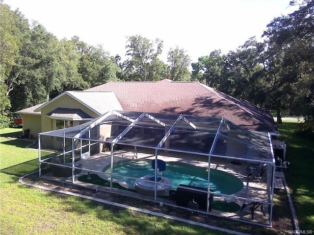1874 W Pearson St, Hernando, FL 34442 - back of house featuring a yard, a patio area, and glass enclosure