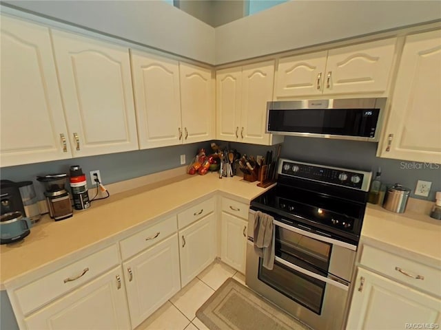 1874 W Pearson St, Hernando, FL 34442 - kitchen with stainless steel appliances and light tile patterned floors