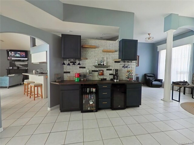 1874 W Pearson St, Hernando, FL 34442 - kitchen with tasteful backsplash, light tile patterned floors, decorative columns, and beverage cooler