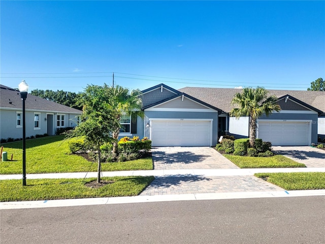 single story home with a garage and a front yard