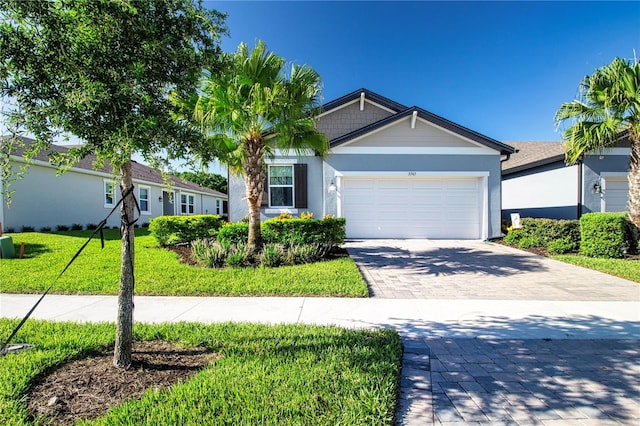 ranch-style house with a garage and a front yard