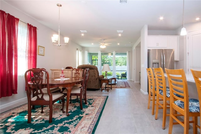 dining space featuring ceiling fan with notable chandelier and light tile patterned floors