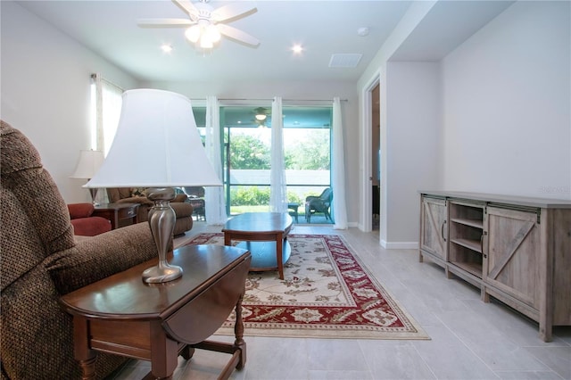 tiled living room with ceiling fan