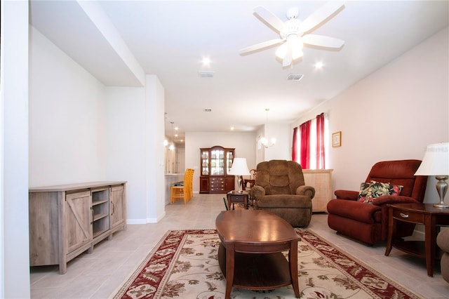 living room with light tile patterned floors and ceiling fan with notable chandelier