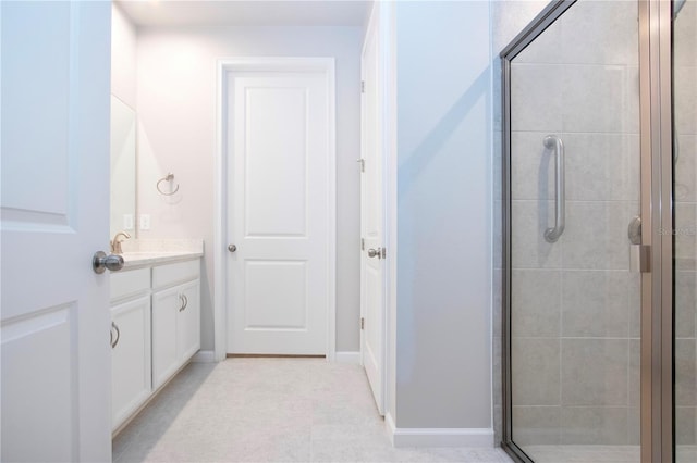 bathroom with walk in shower and vanity