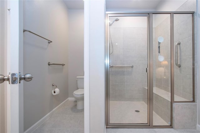 bathroom featuring toilet, an enclosed shower, and tile patterned flooring