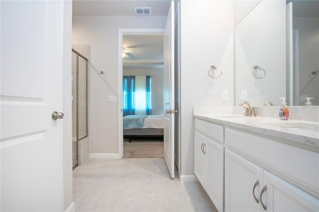 bathroom featuring a shower with shower door and vanity