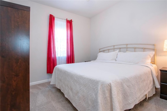 bedroom featuring light colored carpet