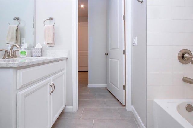 bathroom featuring tiled shower / bath combo, tile patterned floors, and vanity