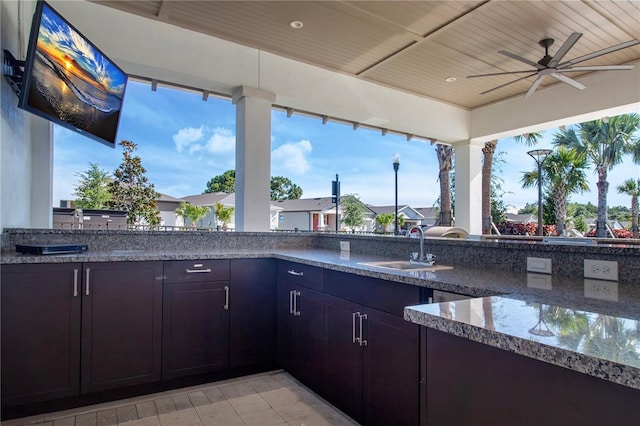 view of patio / terrace featuring ceiling fan, sink, and area for grilling