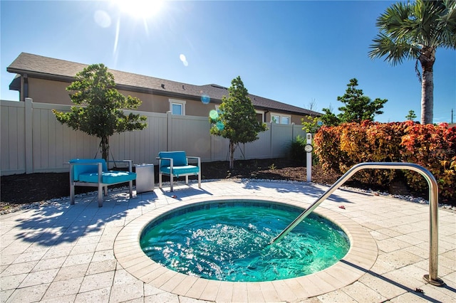 view of swimming pool featuring a patio area and an in ground hot tub