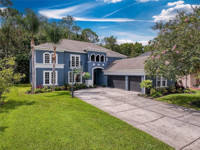 mediterranean / spanish-style house with a garage and a front lawn