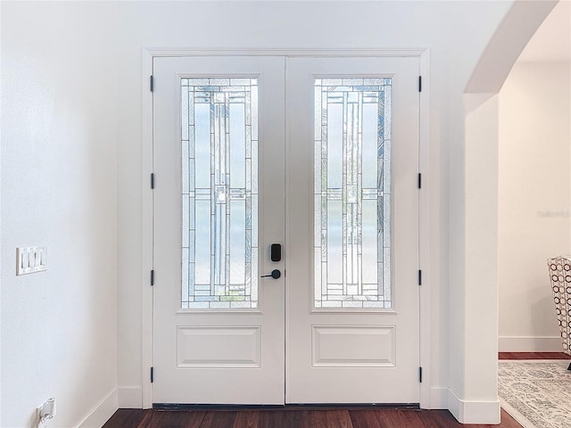 doorway with french doors and dark hardwood / wood-style floors