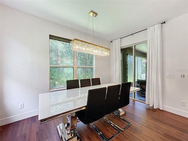 office area with an inviting chandelier and wood-type flooring