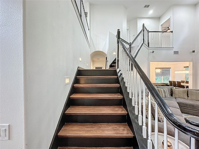 stairway featuring a high ceiling