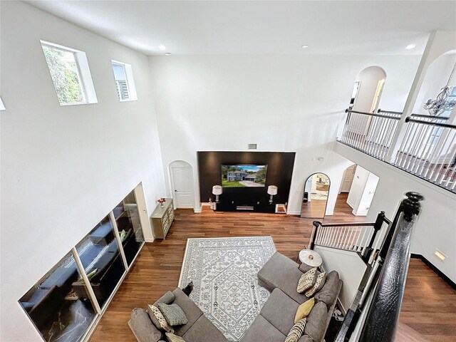 living room featuring dark hardwood / wood-style flooring and a high ceiling