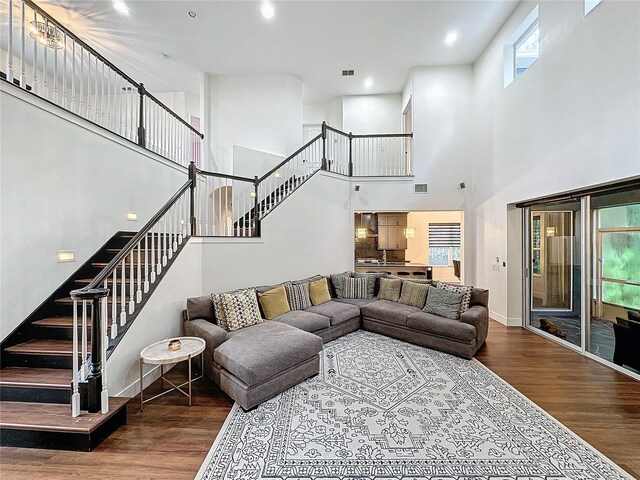 living room featuring a high ceiling and hardwood / wood-style floors