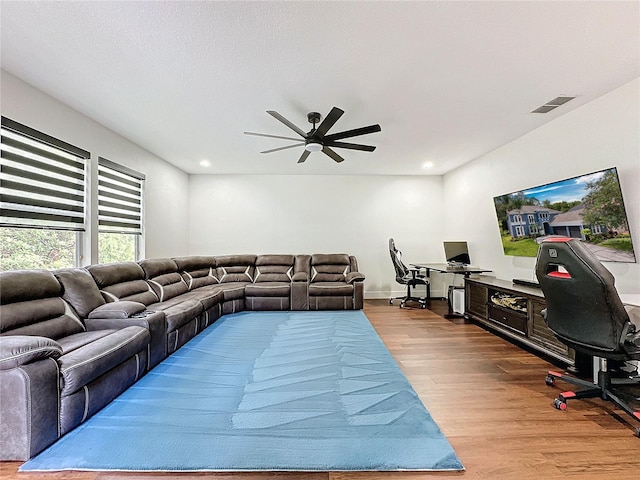 living room with light hardwood / wood-style flooring and ceiling fan