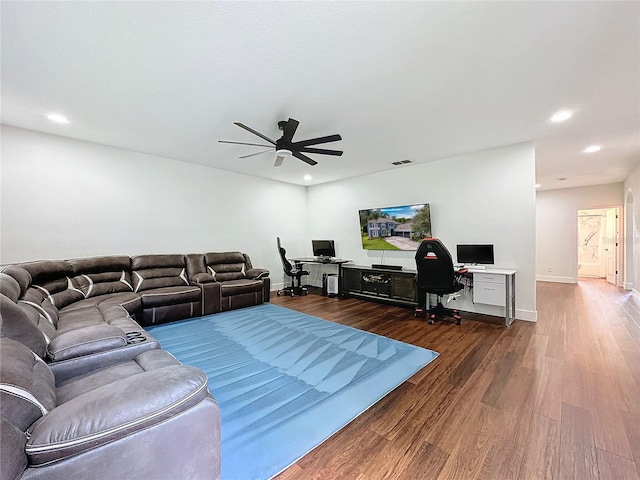 living room with ceiling fan and dark hardwood / wood-style flooring