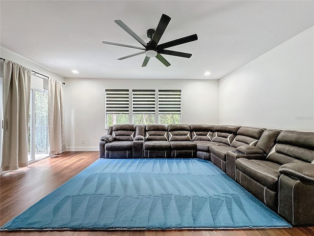 living room featuring ceiling fan, hardwood / wood-style flooring, and a wealth of natural light