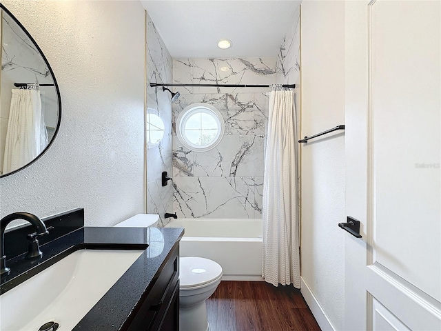 full bathroom featuring vanity, shower / tub combo with curtain, toilet, and hardwood / wood-style floors