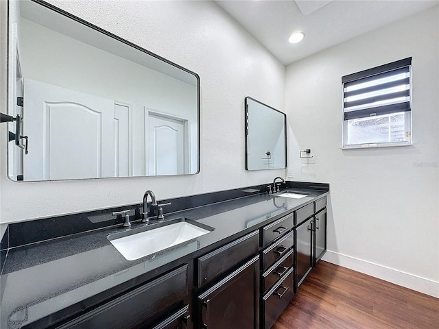 bathroom with double sink vanity and hardwood / wood-style floors