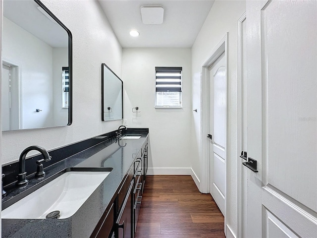 bathroom featuring double vanity and wood-type flooring