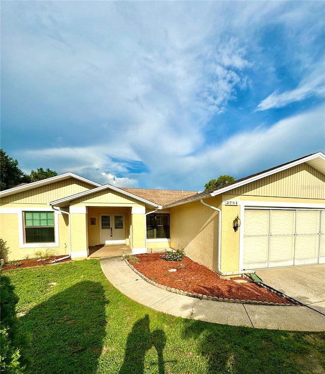 single story home featuring a front yard and a garage