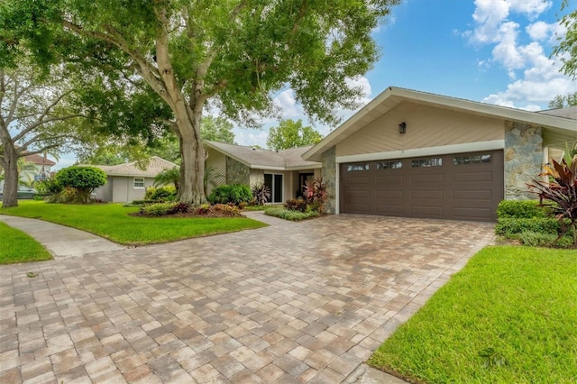 single story home with a garage and a front yard