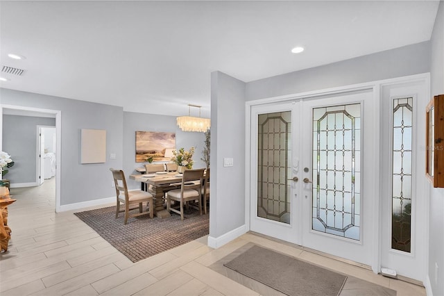 entrance foyer with recessed lighting, french doors, baseboards, and light wood-style floors