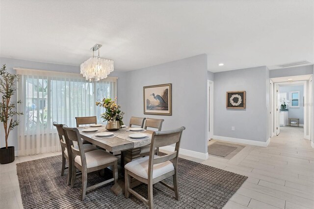 dining room featuring light hardwood / wood-style floors and a chandelier