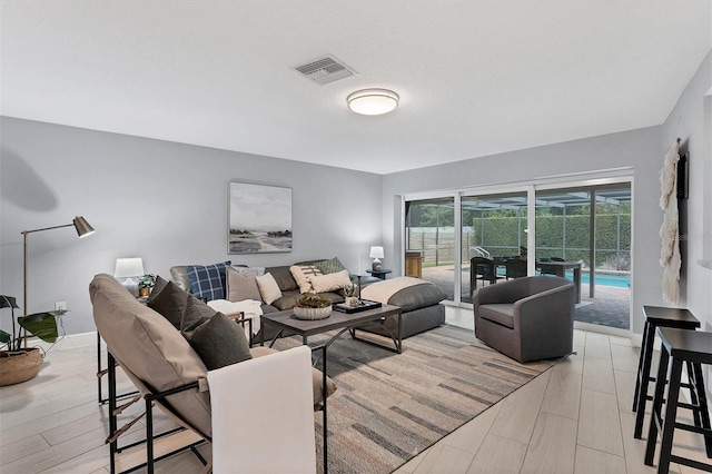 living room featuring visible vents and light wood-style floors