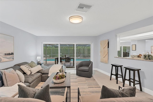 living room featuring visible vents and baseboards