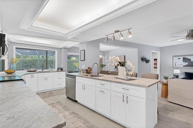 kitchen with white cabinets, sink, a center island, dishwasher, and ceiling fan