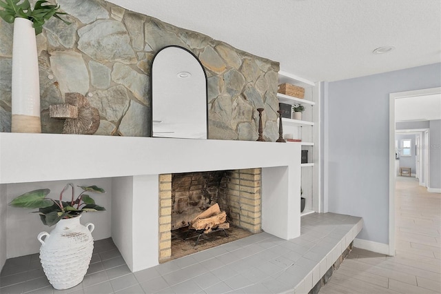 interior details featuring a fireplace and a textured ceiling